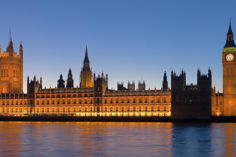 The Palace of Westminster at dusk, seen across the Thames